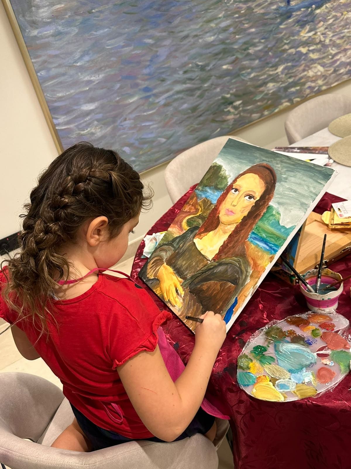 Girl painting her own Mona Lisa at home during a Dolce Arty kids class in Dubai